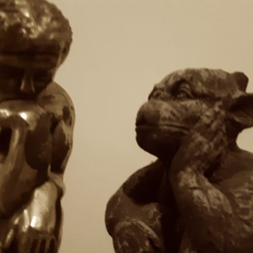 Description for image on page top: “The Thinker” bookend, short-haired figure with head resting on chin, in conversation with small gargoyle, winged creature with one hand resting on face.