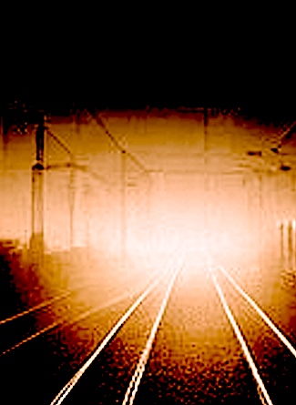 headlight on dark train tracks