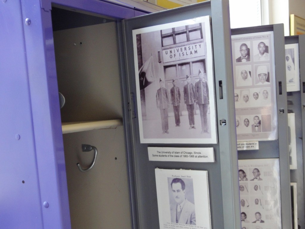 metal school lockers, open for museum exhibit, show "University of Islam" and important portraits
