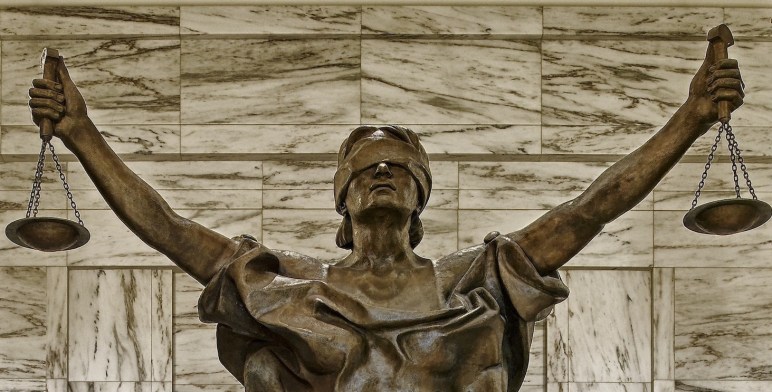 statue of "Justice" with blindfold, holding scales in both hands